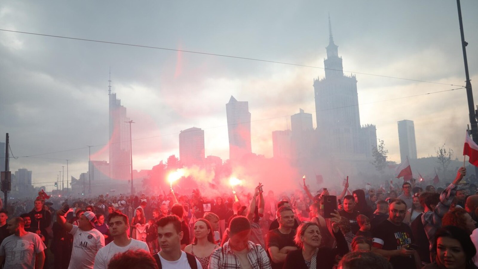 Crowds with Polish flags and red flares in central Warsaw during the annual W Hour commemoration